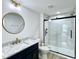 Bathroom with vanity with marble top, modern fixtures, toilet, and hexagon tile shower at 1920 E Epler E Ave, Indianapolis, IN 46227