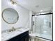 Modern bathroom with navy blue vanity, gold accents, and glass shower with unique tile at 1920 E Epler E Ave, Indianapolis, IN 46227