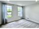 Sunny bedroom with two windows dressed in sheer curtains and neutral carpet at 1920 E Epler E Ave, Indianapolis, IN 46227