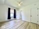 Bright bedroom featuring wood-look floors, neutral walls, access to ensuite bath and natural light at 1920 E Epler E Ave, Indianapolis, IN 46227