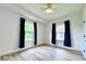 Bedroom features two windows with dark drapes, neutral walls and wood-look flooring at 1920 E Epler E Ave, Indianapolis, IN 46227