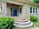 Charming stone home entrance featuring a vibrant blue door, decorative welcome sign, and stone steps at 1920 E Epler E Ave, Indianapolis, IN 46227