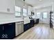 Updated kitchen with white cabinets, gold fixtures and a stainless steel dishwasher at 1920 E Epler E Ave, Indianapolis, IN 46227