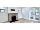 Cozy room with stone fireplace and glass french doors leading to a bright sunroom at 1920 E Epler E Ave, Indianapolis, IN 46227