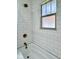 Close-up of shower featuring white subway tile and vintage bronze fixtures at 1920 E Epler E Ave, Indianapolis, IN 46227