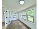 Sunroom with vintage-style tile floors and many windows offering plenty of natural light at 1920 E Epler E Ave, Indianapolis, IN 46227