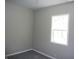 This bedroom offers a bright window and neutral walls, creating a calming and inviting space at 2007 Park Ave, Anderson, IN 46016