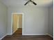 Bright bedroom featuring wood-look floors, neutral paint, and ceiling fan at 2007 Park Ave, Anderson, IN 46016