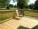 Wooden deck area with chairs and wood railings at 2007 Park Ave, Anderson, IN 46016