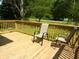 Wooden deck area with chairs and wood railings at 2007 Park Ave, Anderson, IN 46016