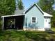 Charming home exterior with blue siding, white trim, carport, and well-maintained lawn at 2007 Park Ave, Anderson, IN 46016