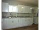 Well-lit kitchen with white cabinets, granite countertops, and modern fixtures at 2007 Park Ave, Anderson, IN 46016