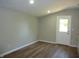 Bright and airy kitchen with wood-look floors, white cabinets, and modern lighting at 2007 Park Ave, Anderson, IN 46016