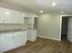Well-lit kitchen with white cabinets, granite countertops, wood-look floors at 2007 Park Ave, Anderson, IN 46016