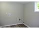 Laundry room with hookups, white trim, light gray walls, and wood-look flooring at 2007 Park Ave, Anderson, IN 46016