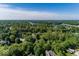 Community aerial view showcasing a wooded neighborhood near a lake, offering a blend of nature and convenience at 21218 Carlton Ct, Noblesville, IN 46062