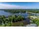 Aerial view of a community with lake access, showcasing waterfront properties and a nearby bridge and marina at 21218 Carlton Ct, Noblesville, IN 46062