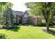 Well-maintained brick home with lush landscaping, mature trees, and a sprawling green lawn at 21218 Carlton Ct, Noblesville, IN 46062