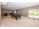 Basement featuring a billiards table, a seating area, and a walkout door at 21218 Carlton Ct, Noblesville, IN 46062