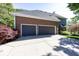 Spacious two-car garage with a paved driveway, featuring a brick facade and modern gray doors at 21218 Carlton Ct, Noblesville, IN 46062
