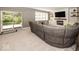 Large living room featuring walkout doors and fireplace with a comfortable gray sofa at 21218 Carlton Ct, Noblesville, IN 46062