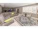 Spacious living room with a gray sofa, accent chairs, and a stylish patterned rug at 21218 Carlton Ct, Noblesville, IN 46062