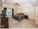 Spacious main bedroom showcasing a tray ceiling, plush carpet, and plenty of natural light from the large windows at 21218 Carlton Ct, Noblesville, IN 46062