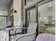 Comfortable seating on a balcony with sliding glass doors overlooking the home's interior at 222 N East St # 103, Indianapolis, IN 46204