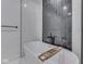 Modern bathroom featuring a freestanding tub with a black faucet and white marble tile at 222 N East St # 103, Indianapolis, IN 46204