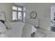 Bright bedroom featuring a white dresser with a mirror and a cozy bed with plush pillows at 222 N East St # 103, Indianapolis, IN 46204