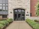 Exterior building entrance with stone facade and well-maintained landscaping at 222 N East St # 103, Indianapolis, IN 46204