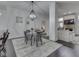 Stylish dining area featuring a modern chandelier and views into the living room at 222 N East St # 103, Indianapolis, IN 46204