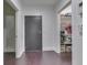 Bright entryway with dark wood floors, closet, and access to other rooms at 222 N East St # 103, Indianapolis, IN 46204