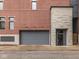 Modern apartment building with a large garage and stone facade at 222 N East St # 103, Indianapolis, IN 46204