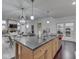 Kitchen island with sink, and view of the dining area, living room and outdoor views at 222 N East St # 103, Indianapolis, IN 46204