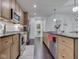 Eat-in kitchen with stainless steel appliances, island seating and dark hardwood floors at 222 N East St # 103, Indianapolis, IN 46204