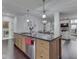 Spacious kitchen island features a sink, stainless steel dishwasher, and wooden drawers at 222 N East St # 103, Indianapolis, IN 46204
