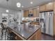 Gourmet kitchen with stainless steel appliances, granite countertops, and counter seating at 222 N East St # 103, Indianapolis, IN 46204