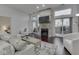 Spacious living room featuring a stone fireplace and sliding glass doors to the balcony at 222 N East St # 103, Indianapolis, IN 46204