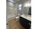 Updated bathroom with modern vanity, bright window, and tub shower combo at 223 N Coventry Dr, Anderson, IN 46012