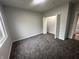 Comfortable bedroom featuring plush carpet, neutral paint, and open closet at 223 N Coventry Dr, Anderson, IN 46012