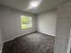 Cozy bedroom with neutral colors, new carpet, and a bright window at 223 N Coventry Dr, Anderson, IN 46012