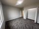 Bedroom with plush carpet, neutral paint and a view through a large bright window at 223 N Coventry Dr, Anderson, IN 46012
