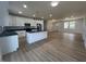 Spacious open-concept kitchen with white cabinets, stainless steel appliances, and a stylish center island at 223 N Coventry Dr, Anderson, IN 46012