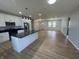 Open-concept kitchen featuring white cabinets, black countertops, stainless appliances and an island at 223 N Coventry Dr, Anderson, IN 46012