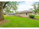 Large backyard and exterior of home, with a stone facade at 3027 Griffa Ave, Columbus, IN 47203
