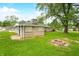 Charming home featuring a spacious backyard with a stone chimney, fire pit and lush lawn at 3027 Griffa Ave, Columbus, IN 47203