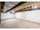 Unfinished basement featuring painted block walls and exposed ceiling at 3027 Griffa Ave, Columbus, IN 47203