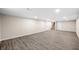 Finished basement featuring vinyl floors, recessed lighting and a view of the stairs and storage closets at 3027 Griffa Ave, Columbus, IN 47203