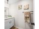 Clean half-bathroom with vanity, mirror, and decorative wall art at 3027 Griffa Ave, Columbus, IN 47203